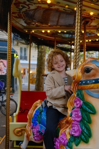 Child on Paris carousel